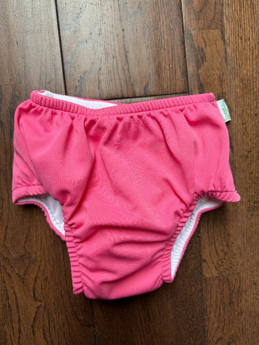 Green Sprouts reusable swim diaper in bright pink, size 3T (30–38 lbs)